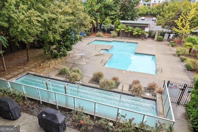 view of pool with a grill and a patio area