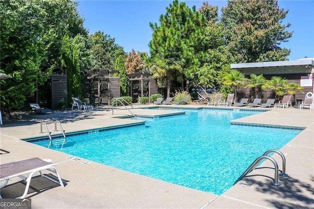 view of swimming pool with a patio area