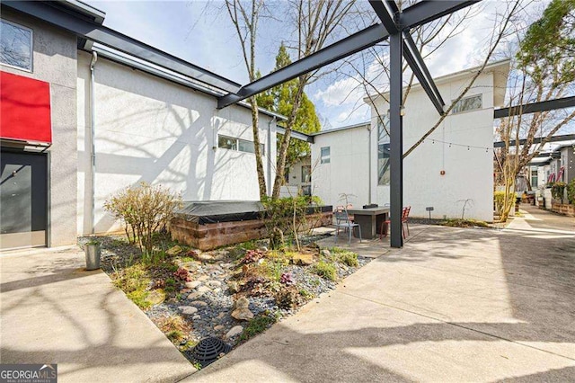 view of side of home featuring a patio