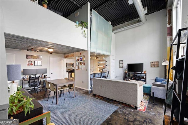 living room featuring a towering ceiling