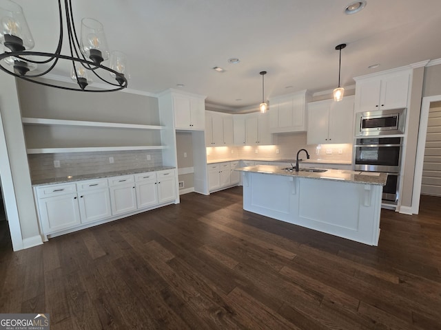 kitchen with sink, white cabinetry, stainless steel appliances, dark hardwood / wood-style floors, and light stone countertops