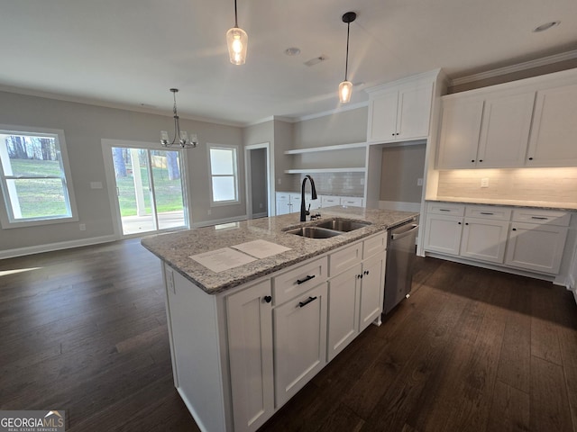 kitchen with pendant lighting, white cabinetry, dishwasher, sink, and a kitchen island with sink