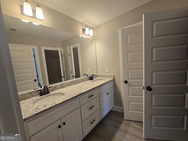 bathroom featuring hardwood / wood-style flooring and vanity