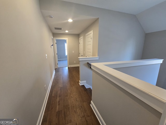 corridor featuring dark hardwood / wood-style flooring and lofted ceiling