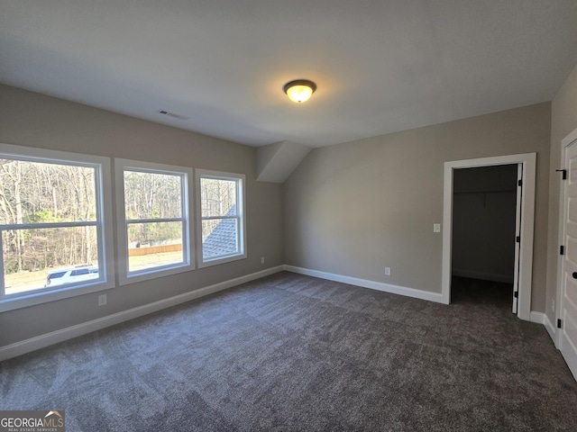 bonus room featuring dark colored carpet