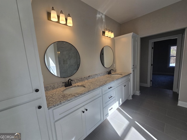 bathroom with tile patterned floors and vanity