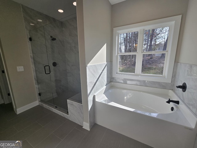 bathroom with a wealth of natural light and independent shower and bath