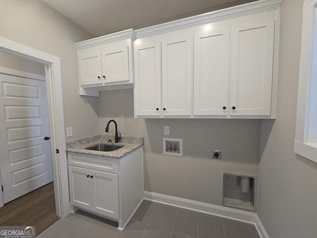 clothes washing area featuring sink, electric dryer hookup, cabinets, washer hookup, and dark hardwood / wood-style flooring