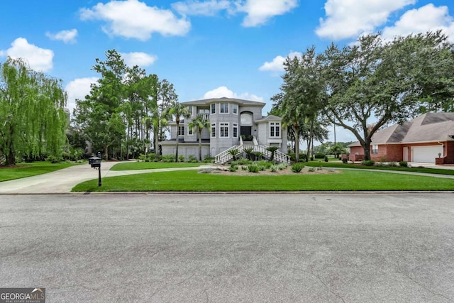 view of front of home with a garage and a front lawn