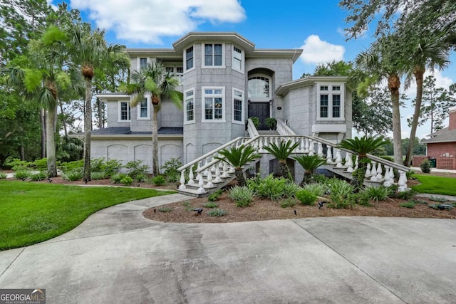 view of front of home featuring a garage and a front yard