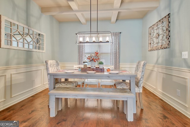 dining space featuring beamed ceiling, coffered ceiling, hardwood / wood-style floors, and a notable chandelier