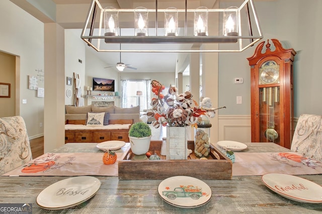 dining room featuring ceiling fan and a towering ceiling