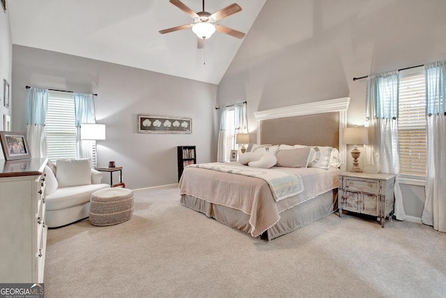 bedroom featuring multiple windows, light carpet, and high vaulted ceiling