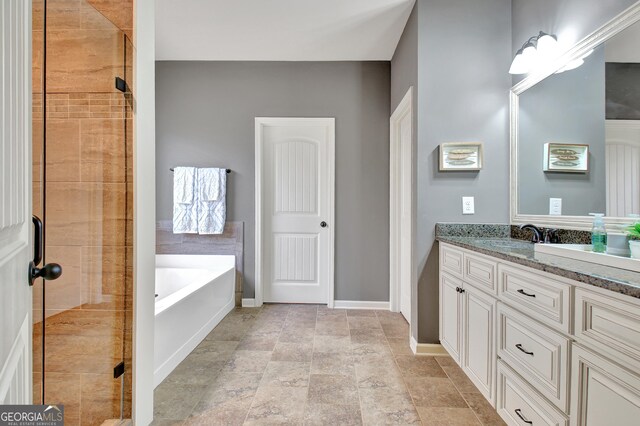 bathroom with independent shower and bath and vanity