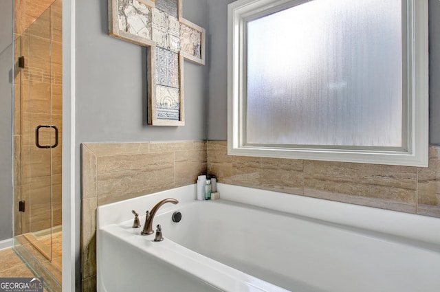 bathroom featuring independent shower and bath