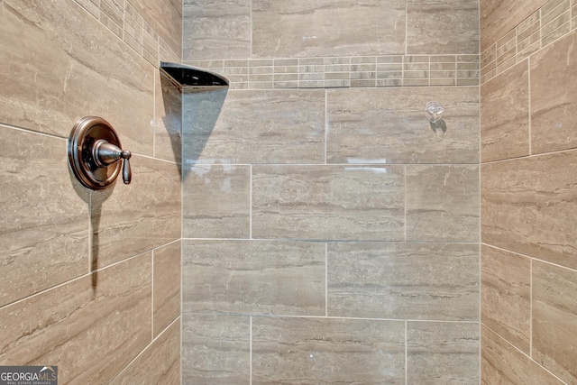 interior details featuring tiled shower