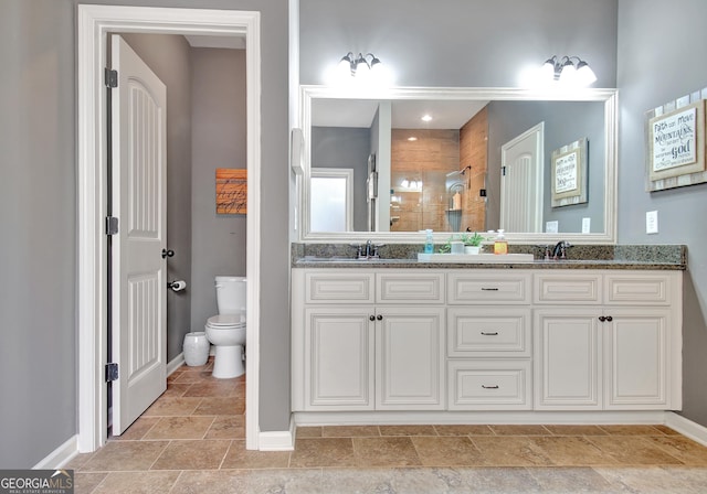 bathroom featuring vanity, toilet, and walk in shower