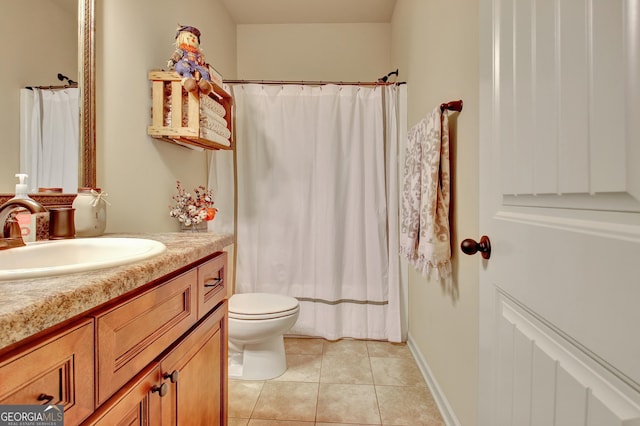 bathroom with tile patterned flooring, vanity, and toilet