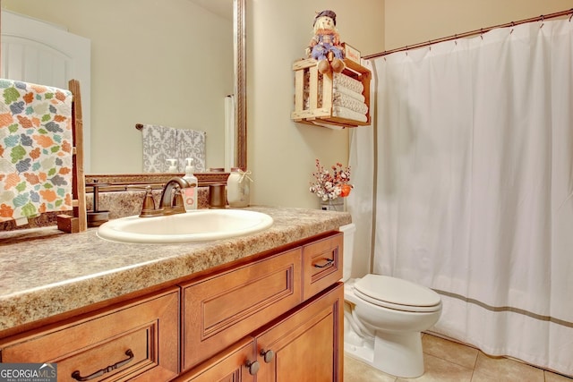 bathroom with vanity, toilet, and tile patterned flooring