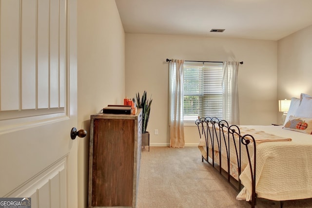 bedroom featuring light carpet