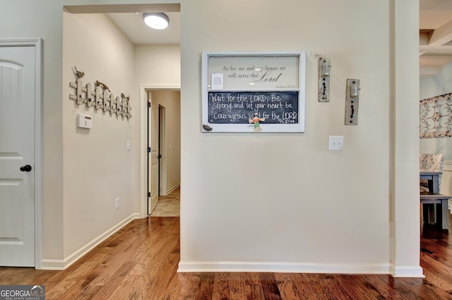 corridor with hardwood / wood-style floors