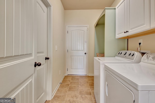 washroom featuring cabinets and separate washer and dryer