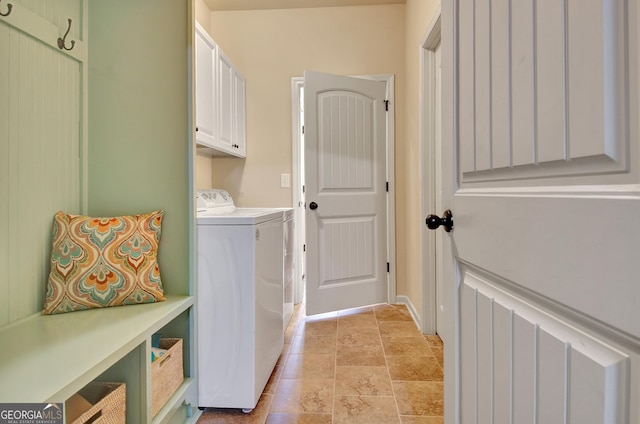 washroom featuring washer and dryer and cabinets