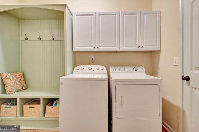 laundry room with independent washer and dryer and cabinets