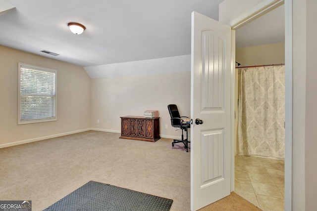 office area featuring light colored carpet and lofted ceiling