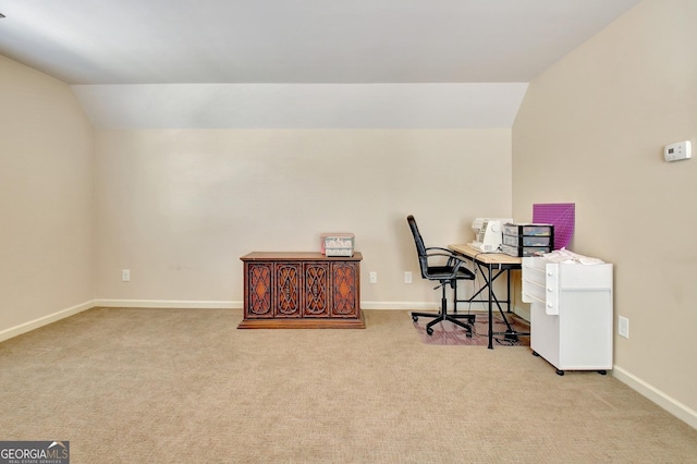 home office featuring light carpet and vaulted ceiling