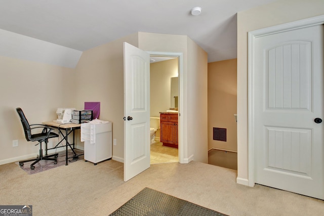 carpeted office space featuring lofted ceiling