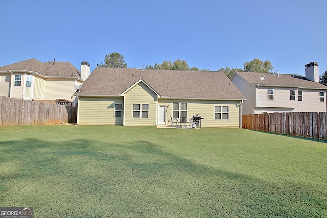 rear view of house featuring a patio and a lawn