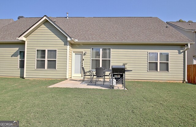 back of property featuring a lawn and a patio area