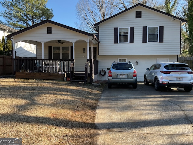 split level home with ceiling fan, a garage, and covered porch