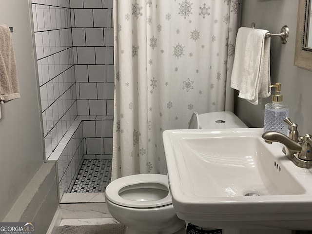 bathroom featuring walk in shower, toilet, and sink