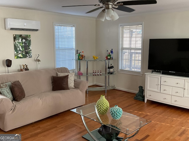 living room featuring crown molding, wood-type flooring, an AC wall unit, and ceiling fan