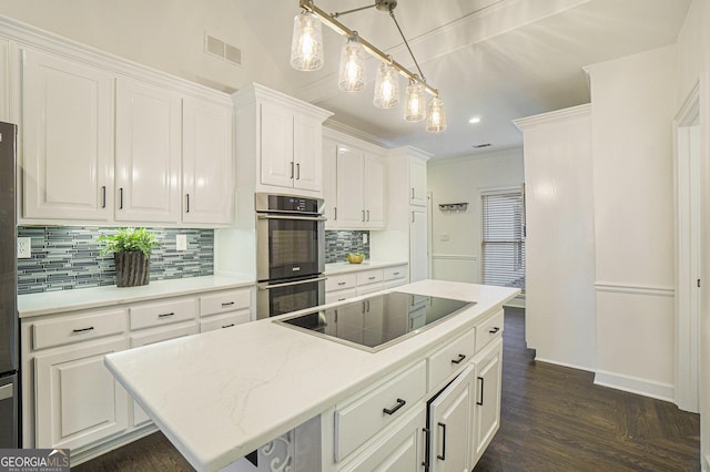 kitchen featuring tasteful backsplash, stainless steel double oven, black electric cooktop, white cabinetry, and a kitchen island