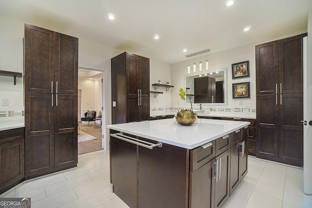 kitchen with a center island, dark brown cabinets, open shelves, light countertops, and recessed lighting