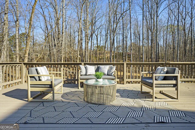 wooden terrace with an outdoor hangout area