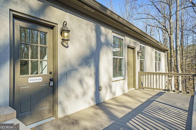 doorway to property featuring stucco siding