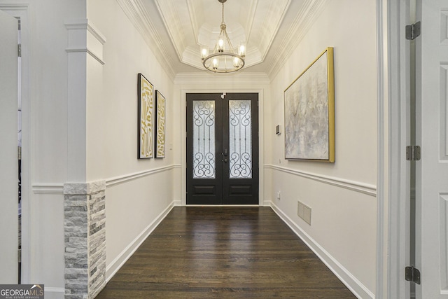 entrance foyer with french doors, visible vents, a notable chandelier, wood finished floors, and ornamental molding