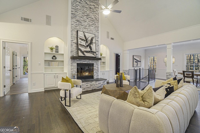 living room with high vaulted ceiling, a ceiling fan, built in shelves, a healthy amount of sunlight, and visible vents