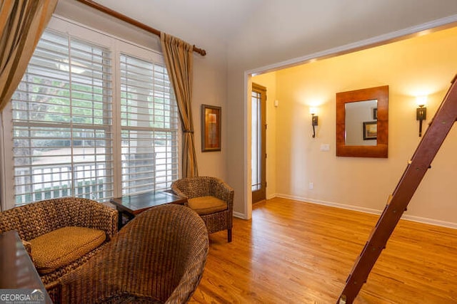 sitting room with baseboards and light wood-style floors