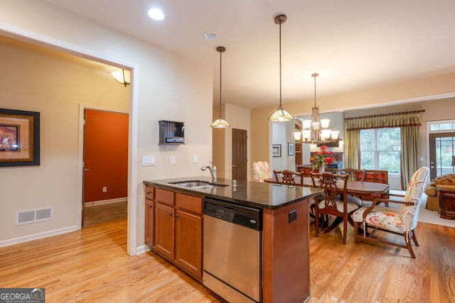 kitchen with a sink, brown cabinets, dishwasher, light wood finished floors, and decorative light fixtures