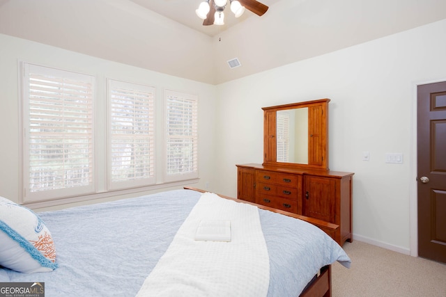 bedroom with light carpet, visible vents, baseboards, a ceiling fan, and vaulted ceiling