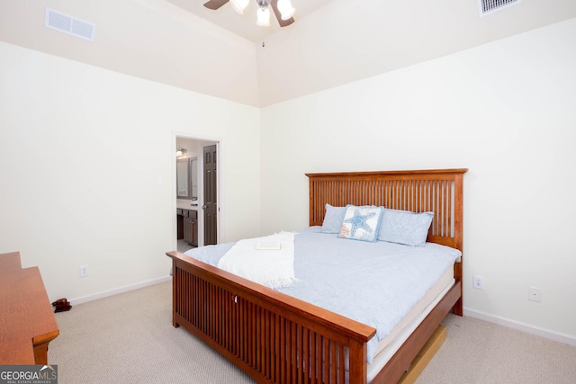 bedroom with ceiling fan, connected bathroom, light carpet, visible vents, and baseboards