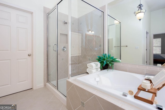 bathroom with a stall shower, a garden tub, and tile patterned floors