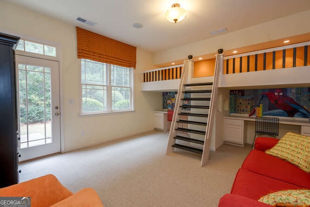 bedroom featuring access to exterior, light colored carpet, and visible vents