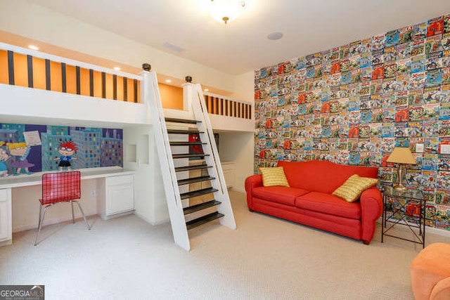 bedroom featuring built in study area and light colored carpet