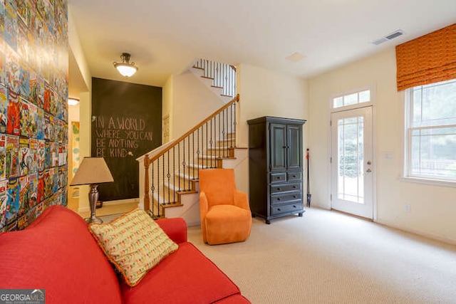 carpeted entryway featuring stairs and visible vents